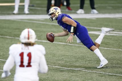 Dec 5, 2020; Seattle, Washington, USA; Washington Huskies quarterback Dylan Morris (9) stumbles after escaping a sack against the Stanford Cardinal during the fourth quarter at Alaska Airlines Field at Husky Stadium. Mandatory Credit: Joe Nicholson-USA TODAY Sports