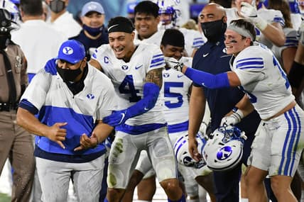 Dec 22, 2020; Boca Raton, Florida, USA; Brigham Young Cougars head coach Kalani Sitake celebrates with defensive back Troy Warner (4) after defeating the UCF Knights at FAU Stadium. Mandatory Credit: Jasen Vinlove-USA TODAY Sports