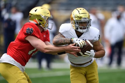 May 1, 2021; Notre Dame, Indiana, USA; Notre Dame Fighting Irish quarterback Jack Coan (17) hands off to running back Kyren Williams (23) in the first quarter of the Blue-Gold Game at Notre Dame Stadium. Mandatory Credit: Matt Cashore-USA TODAY Sports