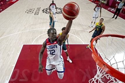 Aug 5, 2021; Saitama, Japan; United States guard Jrue Holiday (12) dunks the ball against Australia in the men's basketball semi final during the Tokyo 2020 Olympic Summer Games at Saitama Super Arena. Mandatory Credit: Kyle Terada-USA TODAY Sports