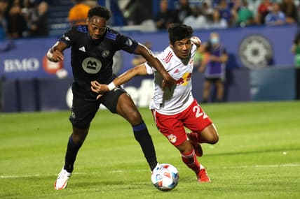Aug 14, 2021; Montreal, Quebec, CAN; CF Montreal forward Mason Toye (13) and New York Red Bulls midfielder Omir Fernandez (21) battle for the ball during the second half at Stade Saputo. Mandatory Credit: Jean-Yves Ahern-USA TODAY Sports