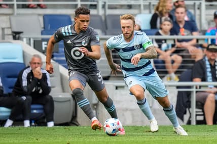 Aug 21, 2021; Saint Paul, MN, USA; Sporting Kansas City forward Johnny Russell (7) dribbles past Minnesota United midfielder Hassani Dotson (31) during the first half at Allianz Field. Mandatory Credit: Brace Hemmelgarn-USA TODAY Sports