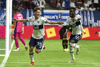 Aug 21, 2021; Vancouver, British Columbia, CAN; Vancouver Whitecaps midfielder Ryan Gauld (25) scores against Los Angeles FC goalkeeper Tomas Romero (30) during the second half at BC Place. Mandatory Credit: Anne-Marie Sorvin-USA TODAY Sports