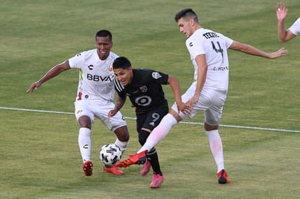 Aug 25, 2021; Los Angeles, CA, USA; Liga MX All-Stars defender Cesar Montes (4) defends against MLS All-Stars forward Raul Ruidiaz (9) in the first half during the 2021 MLS All-Star Game at Banc of California Stadium. Mandatory Credit: Orlando Ramirez-USA TODAY Sports