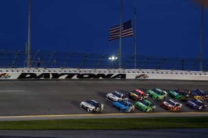Aug 28, 2021; Daytona Beach, Florida, USA;  NASCAR Cup Series driver Denny Hamlin (11) leads through the turn for the Coke Zero 400 at Daytona International Speedway. Mandatory Credit: Nathan Ray Seebeck-USA TODAY Sports
