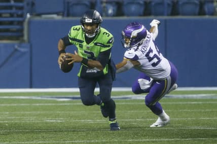 Oct 11, 2020; Seattle, Washington, USA; Seattle Seahawks quarterback Russell Wilson (3) escapes from Minnesota Vikings middle linebacker Eric Kendricks (54) during the fourth quarter at CenturyLink Field. Mandatory Credit: Joe Nicholson-USA TODAY Sports