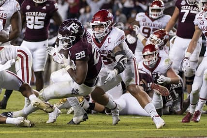 Oct 31, 2020; College Station, TX, USA; Texas A&M running back Isaiah Spiller (28) rushes for a touchdown against Arkansas linebacker Grant Morgan (31) during the second quarter of an NCAA college football game, Saturday, Oct. 31, 2020, in College Station, Texas. Mandatory Credit: Sam Craft/Pool Photo-USA TODAY Sports