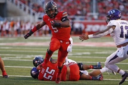 Sep 2, 2021; Salt Lake City, Utah, USA; Utah Utes running back Tavion Thomas (9) runs the ball in the second quarter past Weber State Wildcats linebacker Sherwin Lavaka (13) at Rice-Eccles Stadium. Mandatory Credit: Jeffrey Swinger-USA TODAY Sports