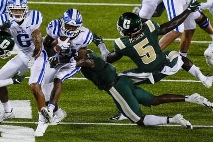 Sep 3, 2021; Charlotte, North Carolina, USA; Duke Blue Devils running back Mataeo Durant (21) is tackled by Charlotte 49ers defensive back Jonathan Alexander (1) during the second quarter at Jerry Richardson Stadium. Mandatory Credit: Jim Dedmon-USA TODAY Sports