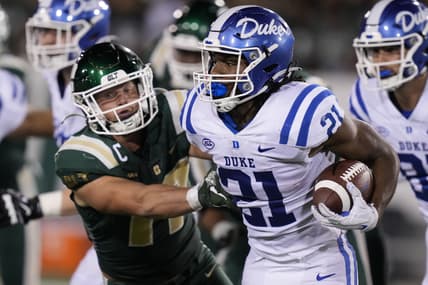 Sep 3, 2021; Charlotte, North Carolina, USA; Duke Blue Devils running back Mataeo Durant (21) is tackled by Charlotte 49ers linebacker Luke Martin (17) during the second quarter at Jerry Richardson Stadium. Mandatory Credit: Jim Dedmon-USA TODAY Sports