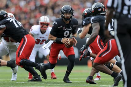Sep 4, 2021; Cincinnati, Ohio, USA; Cincinnati Bearcats quarterback Desmond Ridder (9) tosses the ball against the Miami (Oh) Redhawks in the first half at Nippert Stadium. Mandatory Credit: Aaron Doster-USA TODAY Sports