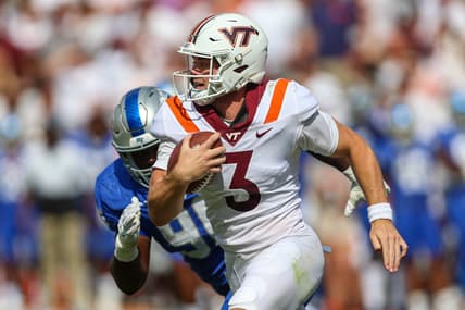 Sep 11, 2021; Blacksburg, Virginia, USA;  Virginia Tech Hokies quarterback Braxton Burmeister (3) runs the ball against Middle Tennessee Blue Raiders defensive lineman Zaylin Wood (96) during the second quarter at Lane Stadium. Mandatory Credit: Ryan Hunt-USA TODAY Sports