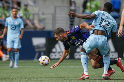 Sep 11, 2021; Seattle, Washington, USA; Seattle Sounders FC forward Will Bruin (17) draws a foul against Minnesota United FC defender Bakaye Dibassy (12) during the first half at CenturyLink Field. Mandatory Credit: Joe Nicholson-USA TODAY Sports
