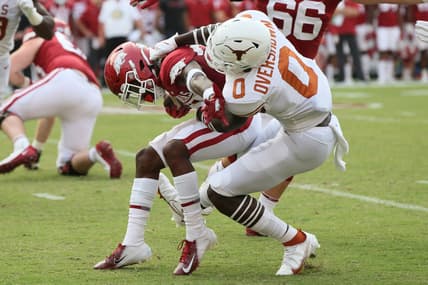 Sep 11, 2021; Fayetteville, Arkansas, USA; Texas Longhorns linebacker DeMarvion Overshow (0) tackles Arkansas Razorbacks running back Trelon Smith (22) during the first quarter at Donald W. Reynolds Razorback Stadium. Mandatory Credit: Nelson Chenault-USA TODAY Sports