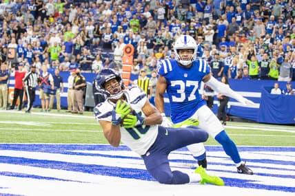 Sep 12, 2021; Indianapolis, Indiana, USA; Seattle Seahawks wide receiver Tyler Lockett (16) catches a touchdown pass while Indianapolis Colts safety Khari Willis (37) defends in the first quarter at Lucas Oil Stadium. Mandatory Credit: Trevor Ruszkowski-USA TODAY Sports