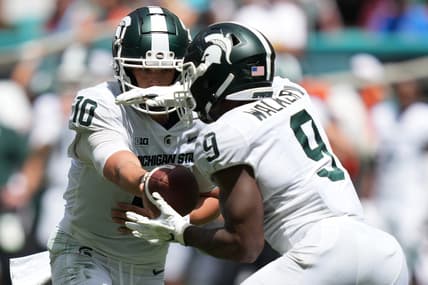 Sep 18, 2021; Miami Gardens, Florida, USA; Michigan State Spartans quarterback Payton Thorne (10) hands the ball to running back Kenneth Walker III (9) during the first half against the Miami Hurricanes at Hard Rock Stadium. Mandatory Credit: Jasen Vinlove-USA TODAY Sports