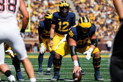 Michigan quarterback Cade McNamara (12) prepares for a snap against Northern Illinois during the first half at Michigan Stadium in Ann Arbor on Saturday, Sept. 18, 2021.