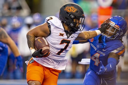 Sep 18, 2021; Boise, Idaho, USA;  Boise State Broncos safety Rodney Robinson (4) gets a stiff arm from Oklahoma State Cowboys running back Jaylen Warren (7) during the first half of play  at Albertsons Stadium. Mandatory Credit: Brian Losness-USA TODAY Sports