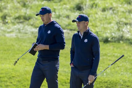 September 22, 2021; Haven, Wisconsin, USA; Team USA players Jordan Spieth (left) and Justin Thomas (right) look on at the 18th green during a practice round for the 43rd Ryder Cup golf competition at Whistling Straits. Mandatory Credit: Kyle Terada-USA TODAY Sports