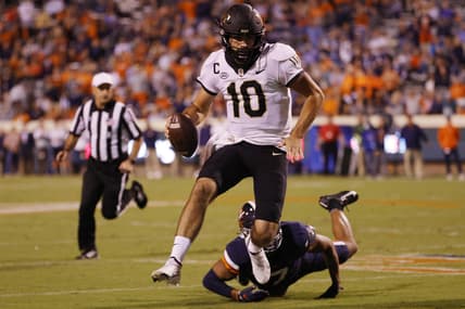 Sep 24, 2021; Charlottesville, Virginia, USA; Wake Forest Demon Deacons quarterback Sam Hartman (10) scrambles past Virginia Cavaliers outside linebacker Noah Taylor (7) during the second quarter at Scott Stadium. Mandatory Credit: Geoff Burke-USA TODAY Sports