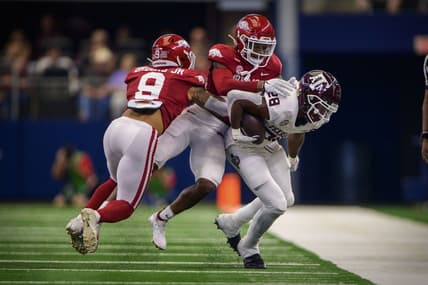 Sep 25, 2021; Arlington, Texas, USA; Arkansas Razorbacks defensive back Greg Brooks Jr. (9) and defensive back LaDarrius Bishop (24) tackle Texas A&M Aggies running back Isaiah Spiller (28) during the first quarter at AT&T Stadium. Mandatory Credit: Jerome Miron-USA TODAY Sports