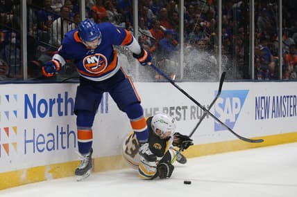 Jun 9, 2021; Uniondale, New York, USA; Boston Bruins center Brad Marchand (63) and New York Islanders defenseman Ryan Pulock (6) fight for the puck during the third period of game six of the third round of the 2021 Stanley Cup Playoffs at Nassau Veterans Memorial Coliseum. Mandatory Credit: Brad Penner-USA TODAY Sports