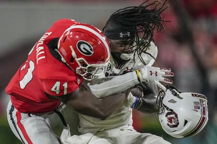 Sep 18, 2021; Athens, Georgia, USA; Georgia Bulldogs linebacker Channing Tindall (41) knocks the helmet of South Carolina Gamecocks wide receiver Dakereon Joyner (5) off on a tackle during the first half at Sanford Stadium. Mandatory Credit: Dale Zanine-USA TODAY Sports