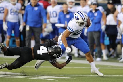 Oct 1, 2021; Logan, Utah, USA; Utah State Aggies running back Calvin Tyler Jr. (4) attempts to tackle Brigham Young Cougars defensive back Talan Alfrey (25) as he runs for a touchdown during the first quarter at Merlin Olsen Field at Maverik Stadium. Mandatory Credit: Rob Gray-USA TODAY Sports