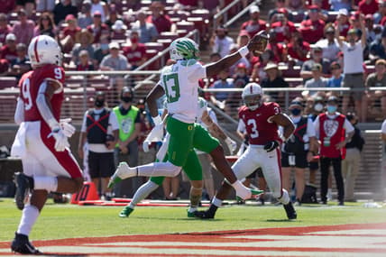 Oct 2, 2021; Stanford, California, USA;  Oregon Ducks quarterback Anthony Brown (13) scores during the second quarter against the Stanford Cardinal at Stanford Stadium. Mandatory Credit: Stan Szeto-USA TODAY Sports