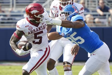 Oct 9, 2021; Oxford, Mississippi, USA; Mississippi Rebels defensive lineman Tavius Robinson (95) grabs the facemark Arkansas Razorbacks running back Raheim Sanders (5) at Vaught-Hemingway Stadium. Mandatory Credit: Marvin Gentry-USA TODAY Sports