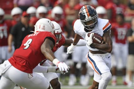 Oct 9, 2021; Louisville, Kentucky, USA;  Virginia Cavaliers wide receiver Dontayvion Wicks (3) runs the ball against Louisville Cardinals linebacker C.J. Avery (9) during the first quarter at Cardinal Stadium. Mandatory Credit: Jamie Rhodes-USA TODAY Sports