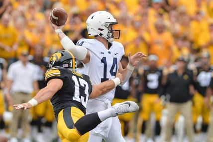 Oct 9, 2021; Iowa City, Iowa, USA; Penn State Nittany Lions quarterback Sean Clifford (14) throws a pass as Iowa Hawkeyes defensive end Joe Evans (13) rushes in during the first quarter at Kinnick Stadium. Mandatory Credit: Jeffrey Becker-USA TODAY Sports