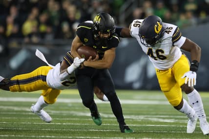 Oct 15, 2021; Eugene, Oregon, USA; Oregon Ducks running back Travis Dye (26) fights for extra yards against California Golden Bears linebacker Marqez Bimage (46) at Autzen Stadium. Mandatory Credit: Jaime Valdez-USA TODAY Sports