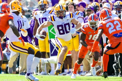 Oct 16, 2021; Baton Rouge, Louisiana, USA; LSU Tigers wide receiver Jack Bech (80) runs against Florida Gators safety Rashad Torrence II (22) during the first half  at Tiger Stadium. Mandatory Credit: Stephen Lew-USA TODAY Sports