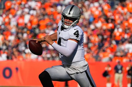 Oct 17, 2021; Denver, Colorado, USA; Las Vegas Raiders quarterback Derek Carr (4) scrambles with the ball in the first half against the Denver Broncos at Empower Field at Mile High. Mandatory Credit: Ron Chenoy-USA TODAY Sports