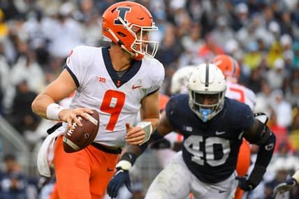 Oct 23, 2021; University Park, Pennsylvania, USA; Illinois Fighting Illini quarterback Artur Sitkowski (9) runs with the ball past Penn State Nittany Lions linebacker Jesse Luketa (40) during the first half at Beaver Stadium. Mandatory Credit: Rich Barnes-USA TODAY Sports