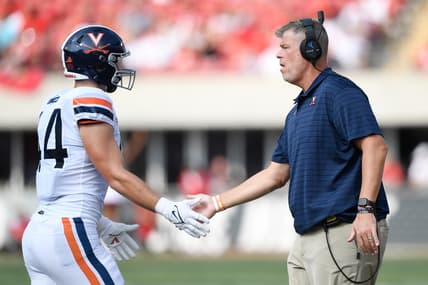 Oct 9, 2021; Louisville, Kentucky, USA;  Virginia Cavaliers head coach Bronco Mendenhall congratulates Virginia Cavaliers tight end Sackett Wood Jr. (44) following a play against the Louisville Cardinals during the first half at Cardinal Stadium. Virginia defeated Louisville 34-33. Mandatory Credit: Jamie Rhodes-USA TODAY Sports