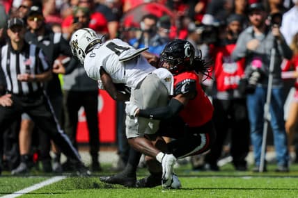 Oct 16, 2021; Cincinnati, Ohio, USA; Cincinnati Bearcats cornerback Arquon Bush (9) brings down UCF Knights wide receiver Ryan O'Keefe (4) in the first half at Nippert Stadium. Mandatory Credit: Katie Stratman-USA TODAY Sports