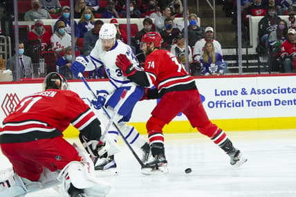 Oct 25, 2021; Raleigh, North Carolina, USA; Carolina Hurricanes defenseman Jaccob Slavin (74) defends against Toronto Maple Leafs center Auston Matthews (34) during the first period at PNC Arena. Mandatory Credit: James Guillory-USA TODAY Sports