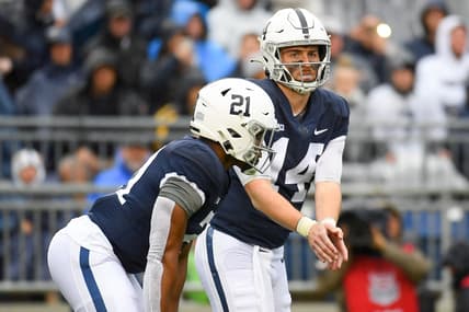 Oct 23, 2021; University Park, Pennsylvania, USA; Penn State Nittany Lions quarterback Sean Clifford (14) calls a play as running back Noah Cain (21) looks on against the Illinois Fighting Illini during the first half at Beaver Stadium. Mandatory Credit: Rich Barnes-USA TODAY Sports