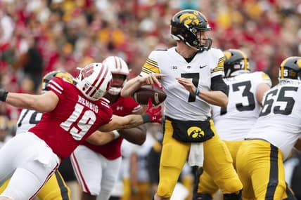 Oct 30, 2021; Madison, Wisconsin, USA;  Wisconsin Badgers linebacker Nick Herbig (19) strips the ball away from Iowa Hawkeyes quarterback Spencer Petras (7) during the second quarter at Camp Randall Stadium. Mandatory Credit: Jeff Hanisch-USA TODAY Sports