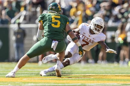 Oct 30, 2021; Waco, Texas, USA; Texas Longhorns running back Keilan Robinson (7) looks for yards past Baylor Bears linebacker Dillon Doyle (5) in the first half of an NCAA football game at McLane Stadium. Mandatory Credit: Stephen Spillman-USA TODAY Sports