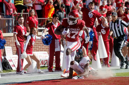 Oklahoma's Marvin Mims (17) scores a touchdown in front of Texas Tech's Malik Dunlap (8) during a college football game between the University of Oklahoma Sooners (OU) and the Texas Tech Red Raiders at Gaylord Family-Oklahoma Memorial Stadium in Norman, Okla., Saturday, Oct. 30, 2021.

Ou Vc Texas Tech