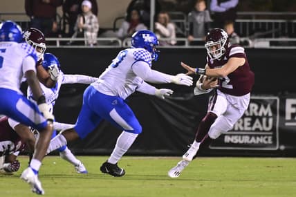 Oct 30, 2021; Starkville, Mississippi, USA; Mississippi State Bulldogs quarterback Will Rogers (2) runs the ball while defended by Kentucky Wildcats defensive lineman Josaih Hayes (99) during the first quarter at Davis Wade Stadium at Scott Field. Mandatory Credit: Matt Bush-USA TODAY Sports