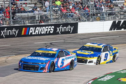 Oct 31, 2021; Martinsville, Virginia, USA; NASCAR Cup Series driver Kyle Larson (5) leads races Chase Elliott (9) at the 73rd Annual Xfinity 500 at Martinsville Speedway. Mandatory Credit: Ryan Hunt-USA TODAY Sports