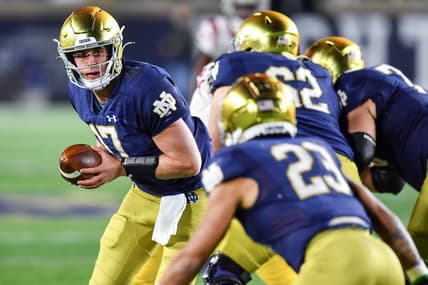 Oct 23, 2021; South Bend, Indiana, USA; Notre Dame Fighting Irish quarterback Jack Coan (17) looks to hand off to running back Kyren Williams (23) in the third quarter against the USC Trojans at Notre Dame Stadium. Mandatory Credit: Matt Cashore-USA TODAY Sports