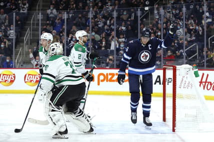Nov 2, 2021; Winnipeg, Manitoba, CAN; Winnipeg Jets right wing Blake Wheeler (26) celebrates the second period goal by Winnipeg Jets defenseman Josh Morrissey (44) on Dallas Stars goaltender Braden Holtby (70) at Canada Life Centre. Mandatory Credit: James Carey Lauder-USA TODAY Sports