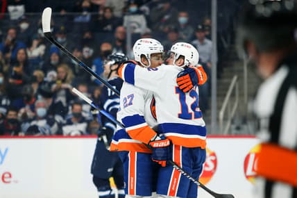 Nov 6, 2021; Winnipeg, Manitoba, CAN; New York Islanders forward Anders Lee (27) celebrates with forward Josh Bailey (12) after scoring a goal against the Winnipeg Jets during the first period at Canada Life Centre. Mandatory Credit: Terrence Lee-USA TODAY Sports
