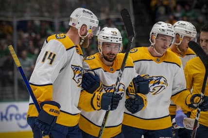 Nov 10, 2021; Dallas, Texas, USA; Nashville Predators defenseman Alexandre Carrier (45) is helped off the ice by defenseman Mattias Ekholm (14) and center Mikael Granlund (64) during the second period against the Dallas Stars at the American Airlines Center. Mandatory Credit: Jerome Miron-USA TODAY Sports