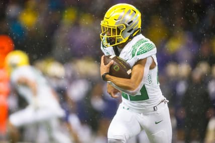 Nov 6, 2021; Seattle, Washington, USA; Oregon Ducks running back Travis Dye (26) rushes against the Washington Huskies during the second quarter at Alaska Airlines Field at Husky Stadium. Mandatory Credit: Joe Nicholson-USA TODAY Sports